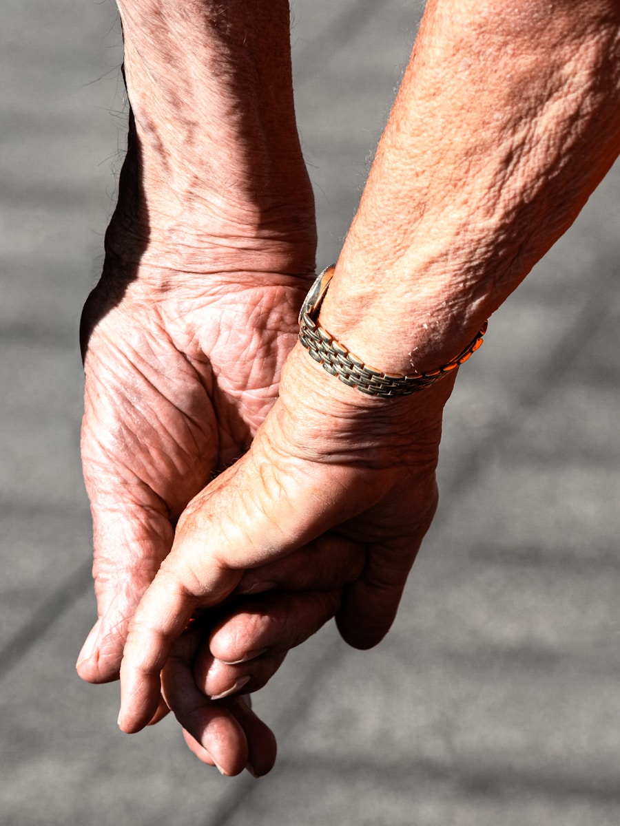 Elderly couple holding hands with a bracelet