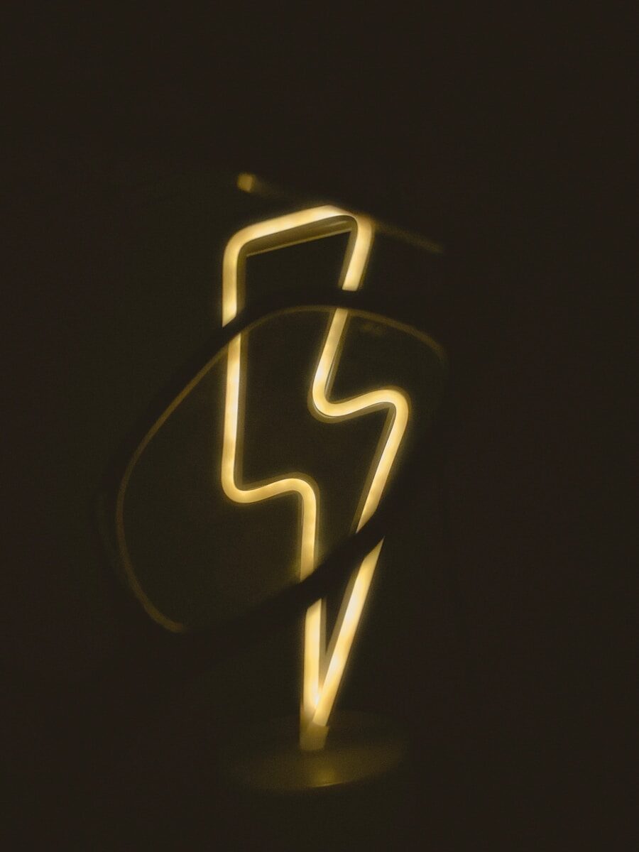 a close up of a neon sign in the dark