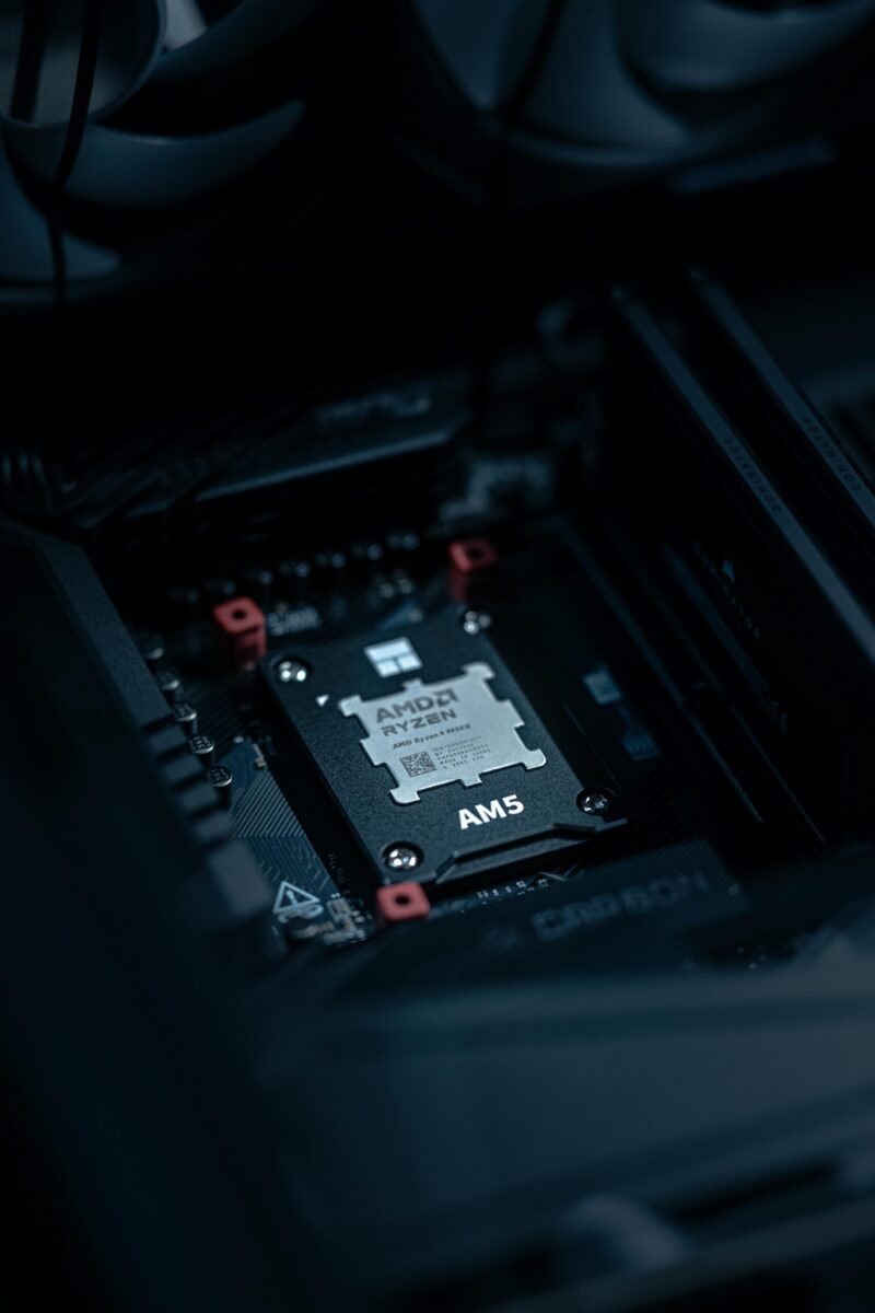 Detailed view of an AMD Ryzen processor securely placed on a motherboard, ideal for tech enthusiasts.