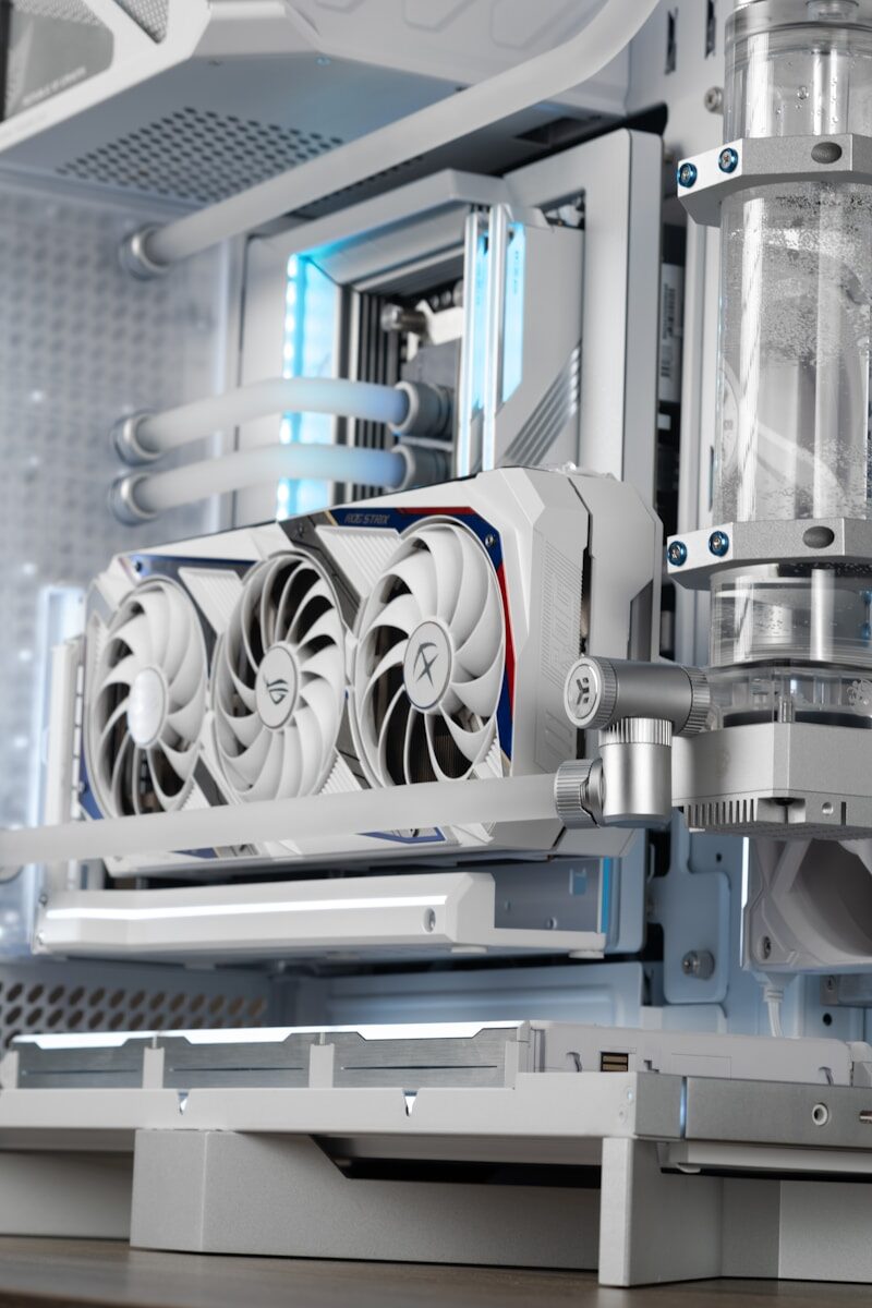 A white PC case with water cooling.